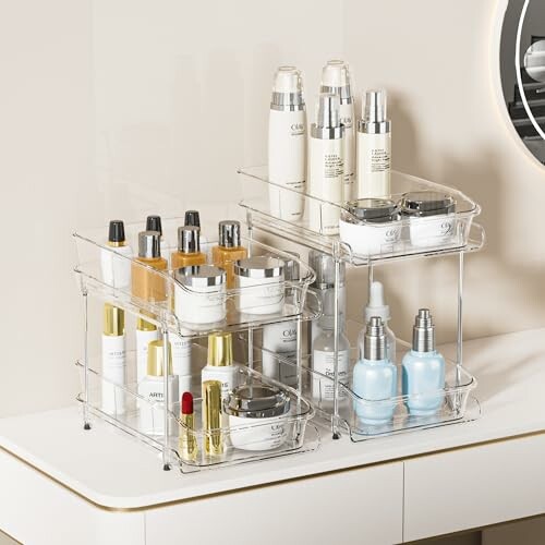 Clear skincare organizers holding various bottles and containers on a vanity.