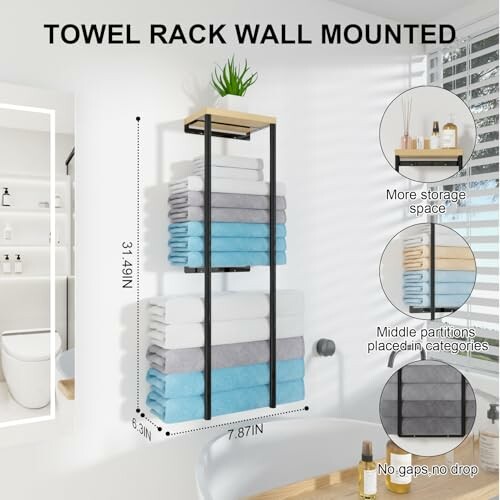 Wall-mounted towel rack with stacked towels and plant.